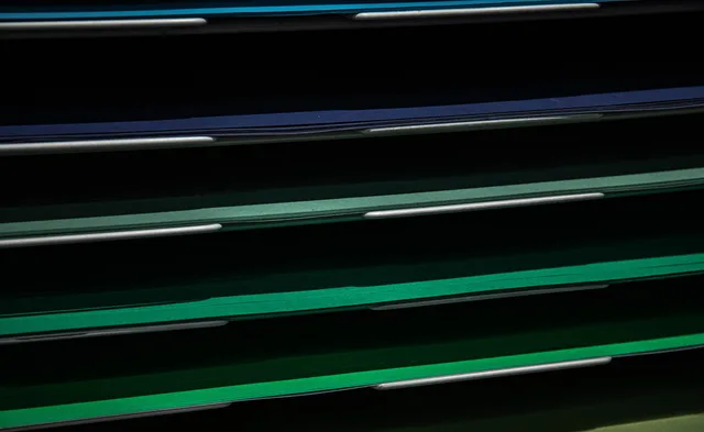 Close-up view of assorted colored paper in a stacking rack, perfect for school or office use. Versioning creative assets across an ad stack